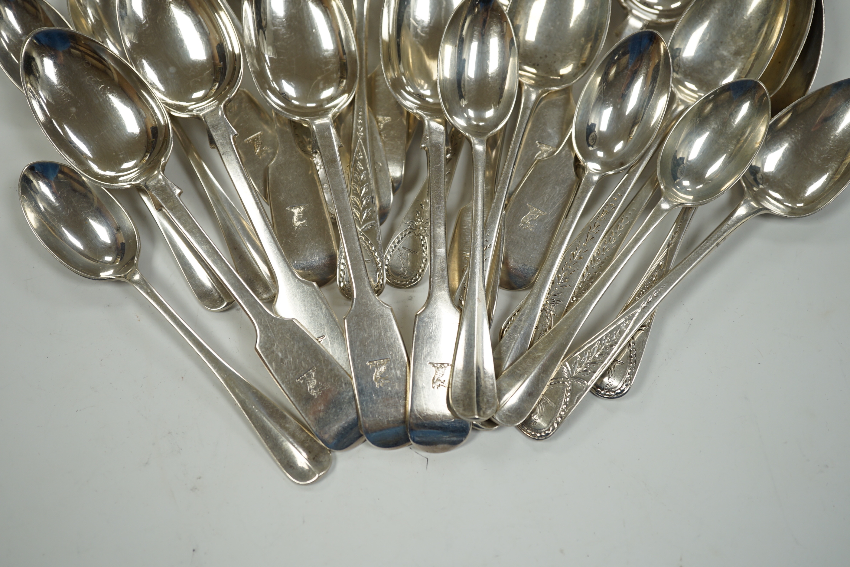 A set of eleven late Victorian silver fiddle pattern teaspoons, London, 1892 and sixteen earlier assorted silver teaspoons, 15.4oz.